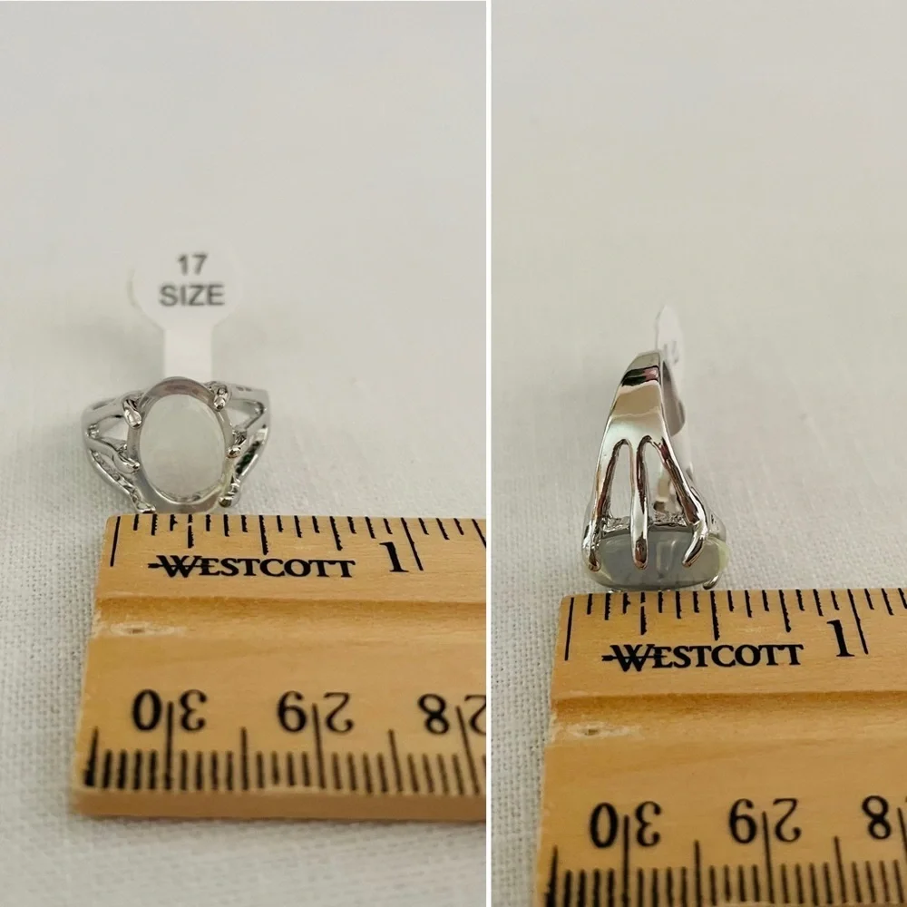 A clear white oval stone on a silvertone ring, US size  6 1/4-6 1/2, NEW
